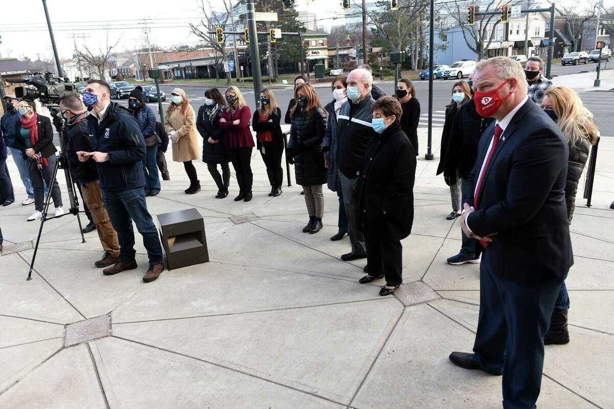 A crowd watches as Police Chief John Sullivan is sworn in by retired Connecticut Supreme Court Justice Lubbie Harper Jr., in front of Hamden Memorial Town Hall on Jan. 6, 2021.