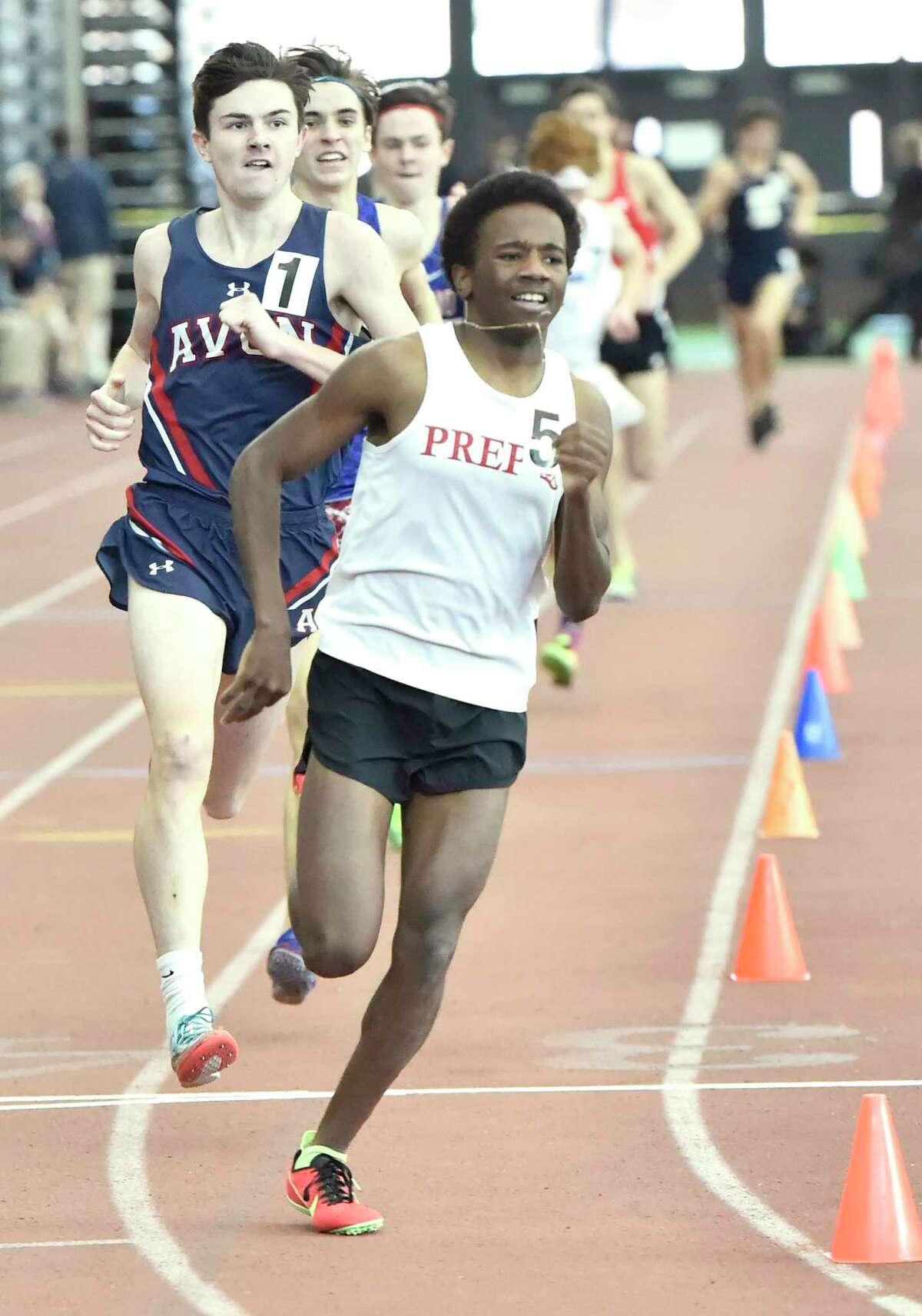 Azaan Dawson of Fairfield Prep leads the pack early against eventual winner Jack Martin of Avon, left, and Alec Sauter of Tolland during the 1600-meter run at the CIAC State Open Indoor Track Championship at the Floyd Little Athletic Center in New Haven in February.