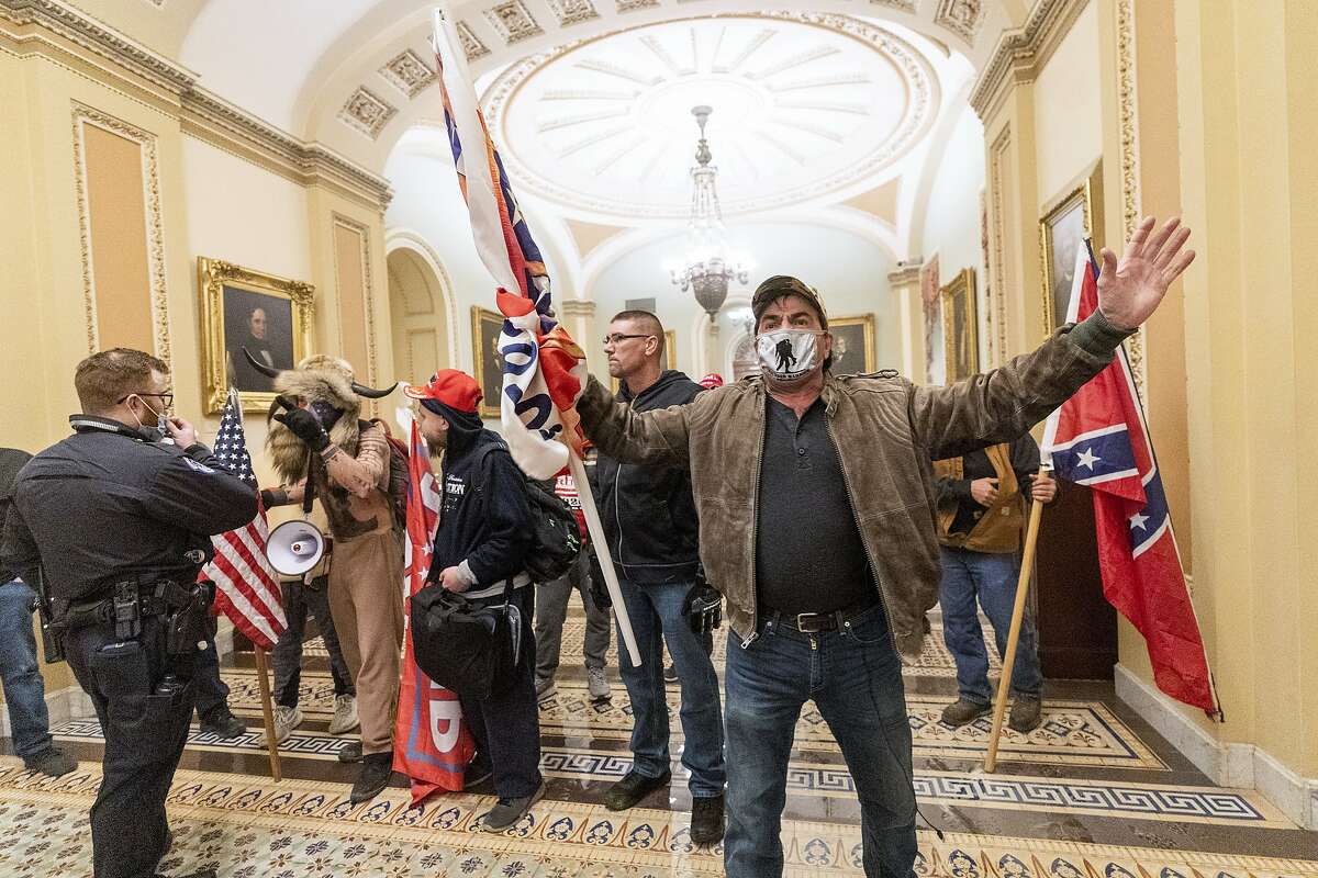 Supporters of President Trump are confronted by U.S. Capitol Police officers confront supporters of President Trump outside the Senate Chamber inside the U.S. Capitol on Wednesday. Leaders of the mob could face legal consequences.