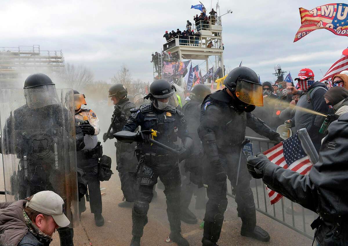 TOPSHOT - Trump supporters clash with police and security forces as they try to storm the US Capitol in Washington, DC on January 6, 2021. - Demonstrators breeched security and entered the Capitol as Congress debated the a 2020 presidential election Electoral Vote Certification. (Photo by Joseph Prezioso / AFP) (Photo by JOSEPH PREZIOSO/AFP via Getty Images)