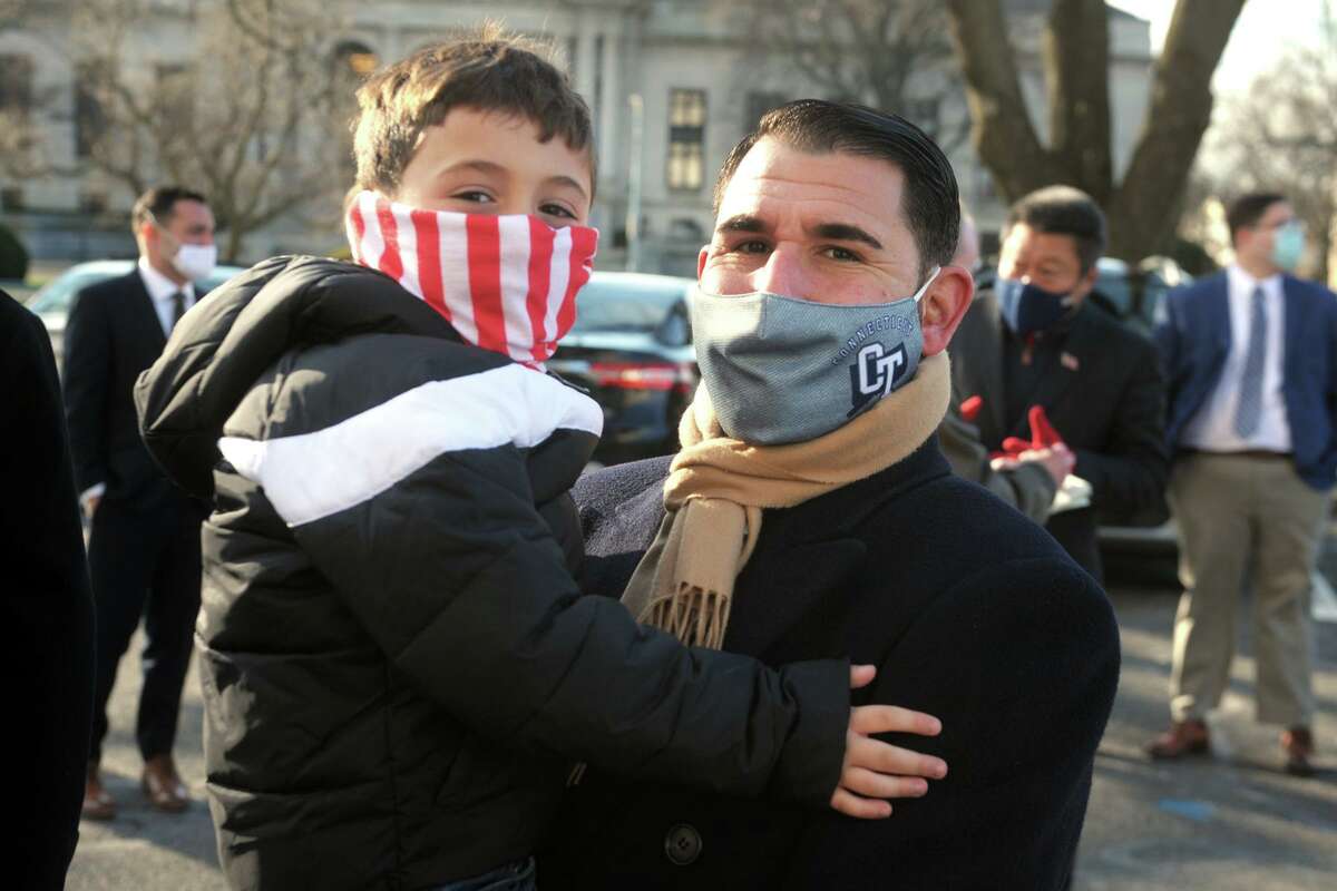 New State Sen. Paul Cicarella, R-North Haven, stands with son, Paul, during the of the start the legislative session held outside at the State Capitol, in Hartford, Conn. Jan. 6, 2021.