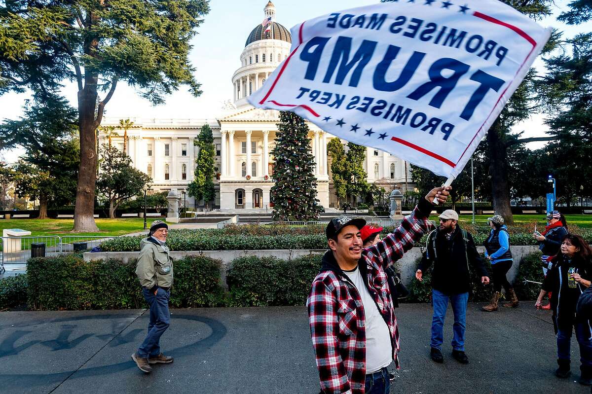 John, who declined to give a last name, protests in support of President Donald Trump outside the California State Capitol on Wednesday, Jan. 6, 2021, in Sacramento, Calif.