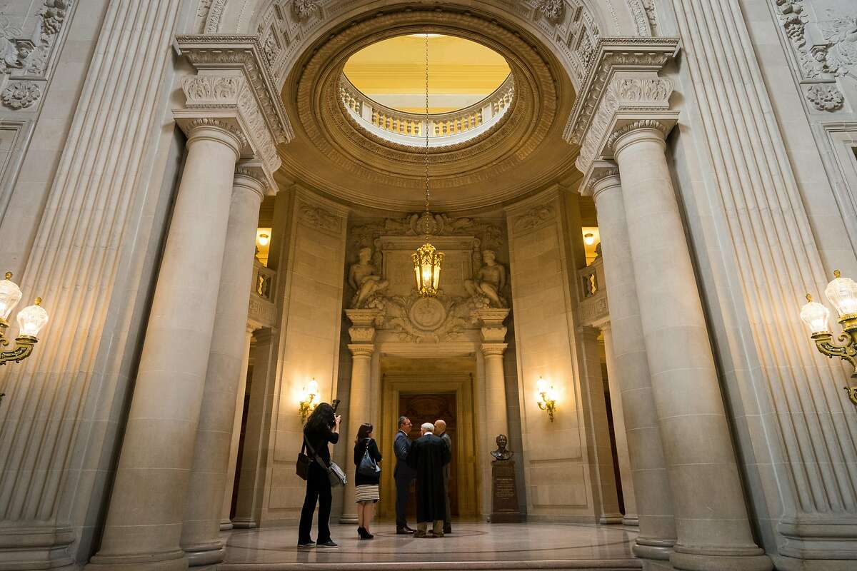 A marriage ceremony takes place in the rotunda of San Francisco City Hall, a masterpiece of Beaux Arts classicism where a supervisor and mayor were assassinated in 1978.