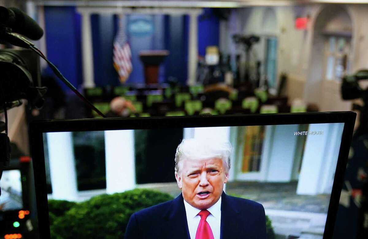 U.S. President Donald Trump is seen on TV from a video message released on Twitter addressing rioters at the U.S. Capitol, in the Brady Briefing Room at the White House in Washington, D.C. on Wednesday, Jan. 6, 2020. Trump told his supporters on Wednesday to "go home" after they stormed the U.S. Capitol following a rally during which he repeated his spurious claims of election fraud. (Mandel Ngan/AFP/Getty Images/TNS)