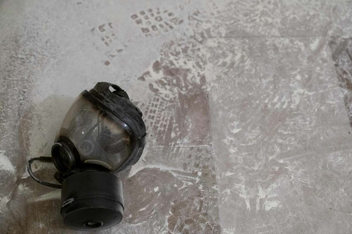Dust and a gas mask are visible on the ground in the early morning hours of Thursday, Jan. 7, 2021, after protesters stormed the Capitol in Washington, on Wednesday. (AP Photo/Andrew Harnik)