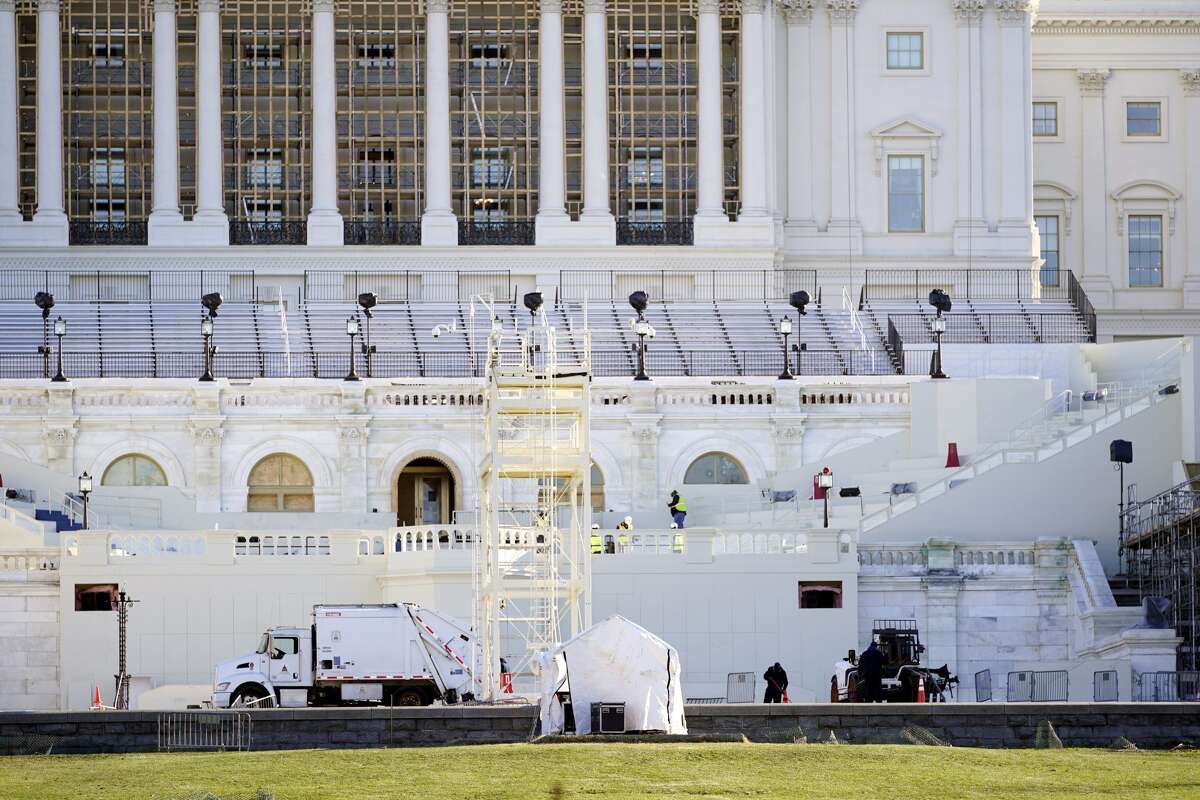 Maintenance workers as shown cleaning outside a mostly quiet Capitol, Thursday morning, Jan. 7, 2021 in Washington. The House and Senate certified the Democrat's electoral college win early Thursday after a violent throng of pro-Trump rioters spent hours Wednesday running rampant through the Capitol. A woman was fatally shot, windows were bashed and the mob forced shaken lawmakers and aides to flee the building, shielded by Capitol Police. (AP Photo/Julio Cortez)