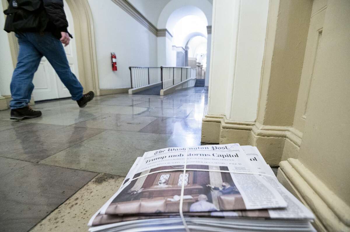 A stack of newspapers sits on the first floor of the House side of the U.S. Capitol on Thursday morning, January 7, 2021, following the riot at the Capitol the day before. (Photo By Bill Clark/CQ-Roll Call, Inc via Getty Images)