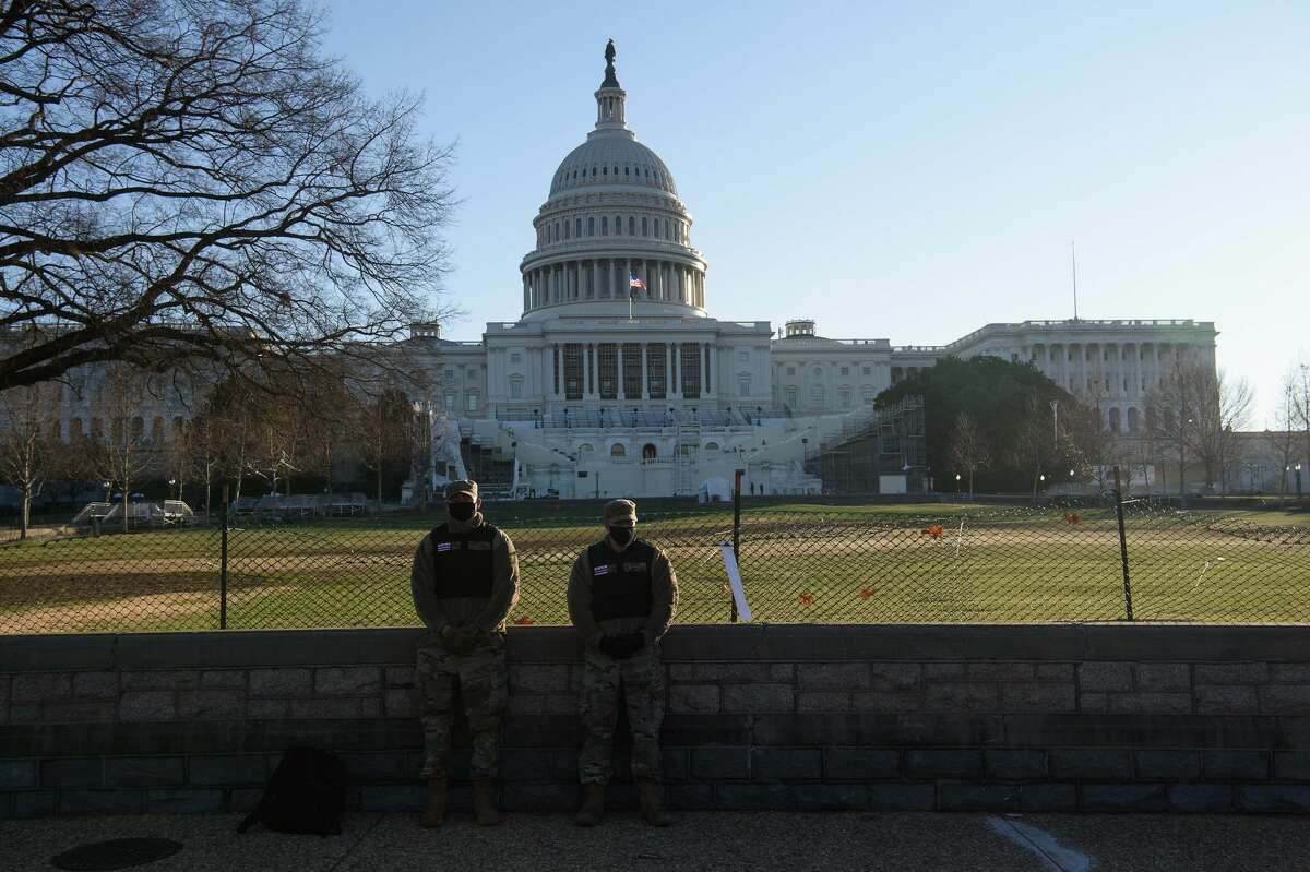 Members of the DC National Guard stand in front of the US Capitol in Washington, DC, on January 7, 2021, one day after supporters of outgoing President Donald Trump stormed the building. (Photo by NICHOLAS KAMM/AFP via Getty Images)
