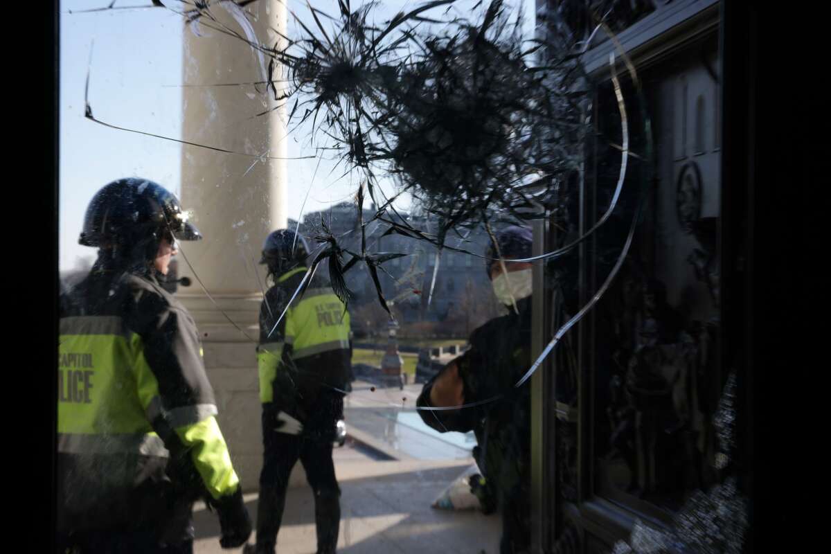 Members of U.S. Capitol Police inspect a damaged entrance of the U.S. Capitol January 7, 2021 in Washington, DC. The U.S. Congress has finished the certification for President-elect Joe Biden and Vice President-elect Kamala Harrisâ electoral college win after pro-Trump mobs stormed the Capitol and temporarily stopped the process. (Photo by Alex Wong/Getty Images)
