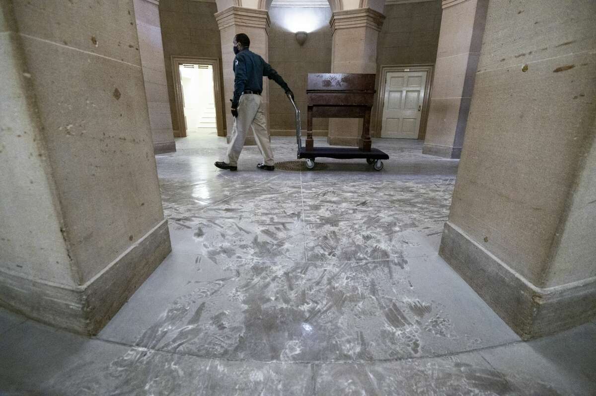 Capitol workers remove damaged furniture on the first floor of the Senate side of the U.S. Capitol on Thursday morning, January 7, 2021, following the riot at the Capitol the day before. (Photo By Bill Clark/CQ-Roll Call, Inc via Getty Images)