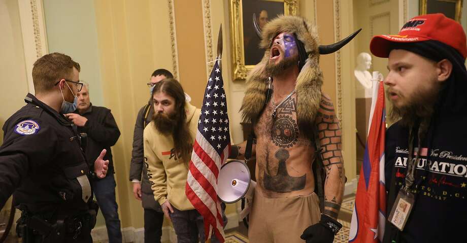 Jake Angeli, who calls himself the Q Shaman, seen inside the Capitol building on Wednesday. Photo: Win McNamee, TNS