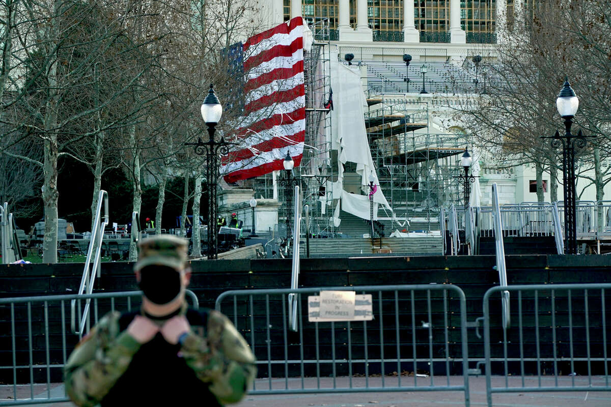 Torn material hangs from scaffolding setup for the inauguration ceremony at the Capitol in Washington on Thursday, Jan. 7, 2021, a day after a mob of President Trump supporters breached Capitol security. President Donald Trump's efforts to overturn the 2020 presidential election came to a dangerous head on Wednesday when a mob of his supporters stormed the Capitol following a rally in which Trump once again falsely claimed widespread voter fraud.
