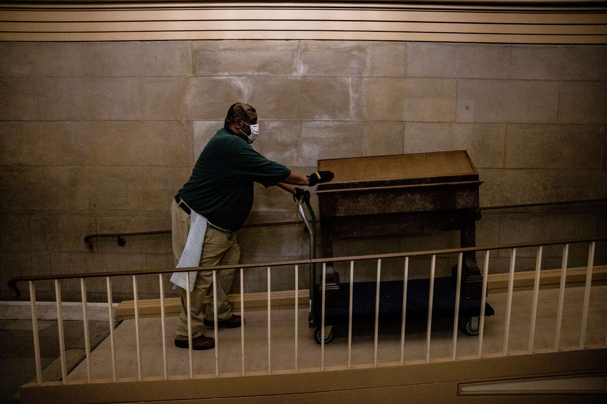 Workers begin to clean up the debris and damage caused by a pro-Trump mob at the U.S. Capitol building on January 7, 2021 in Washington, DC. Following a rally yesterday with President Donald Trump on the National Mall, a pro-Trump mob stormed and broke into the U.S. Capitol building causing a Joint Session of Congress to delay the certification of President-elect Joe Biden's victory over President Trump.