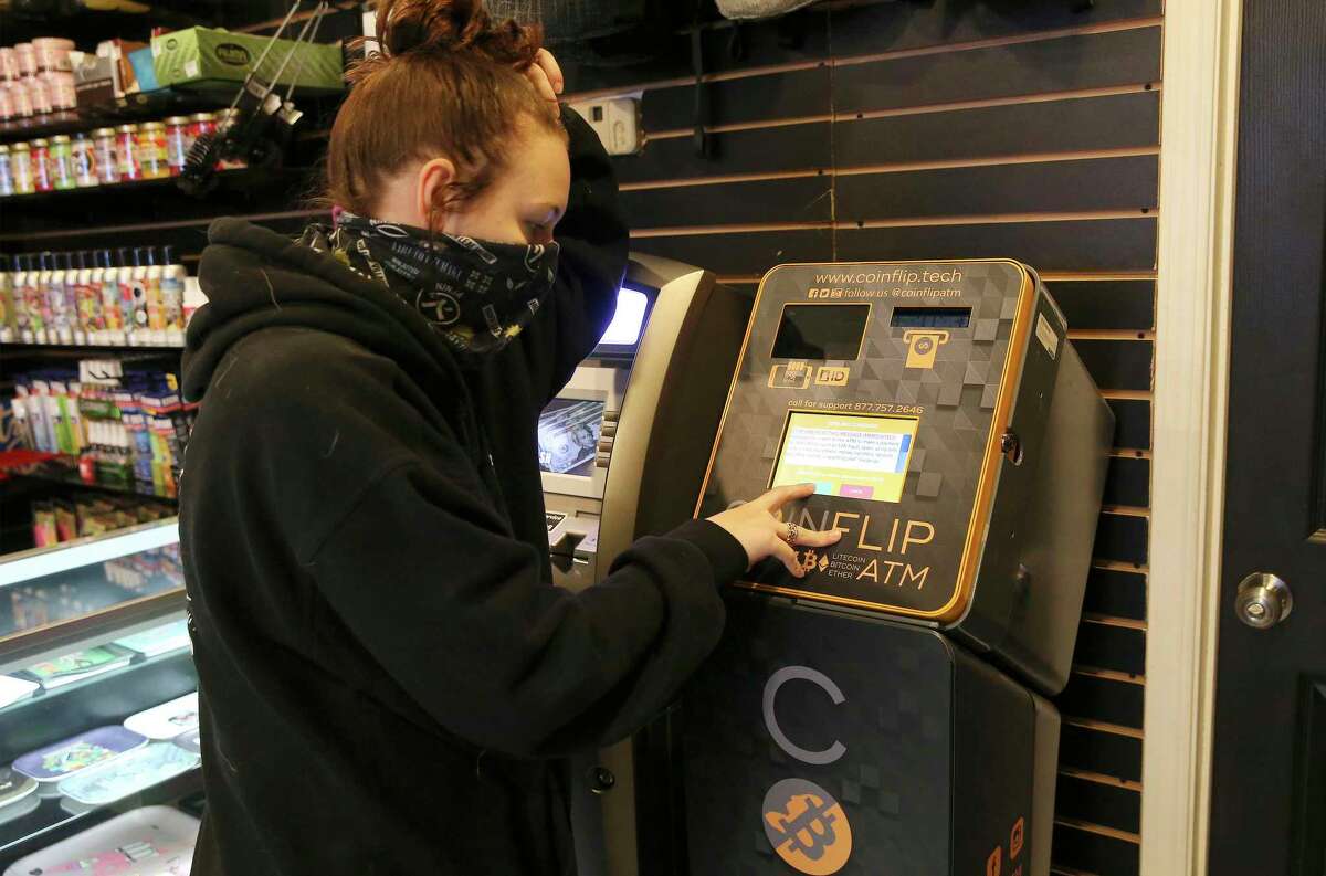 Crypto currency ATMs are popping up throughout San Antonio. Smokerz Paradise offers such a machine for people to conduct crypto currency transactions. Shift leader Bridgette McFarlin demonstrates how to conduct a transaction on one of the ATMs located at Smokerz Paradise near IH10 and DeZavala on Thursday, Jan. 7, 2021.