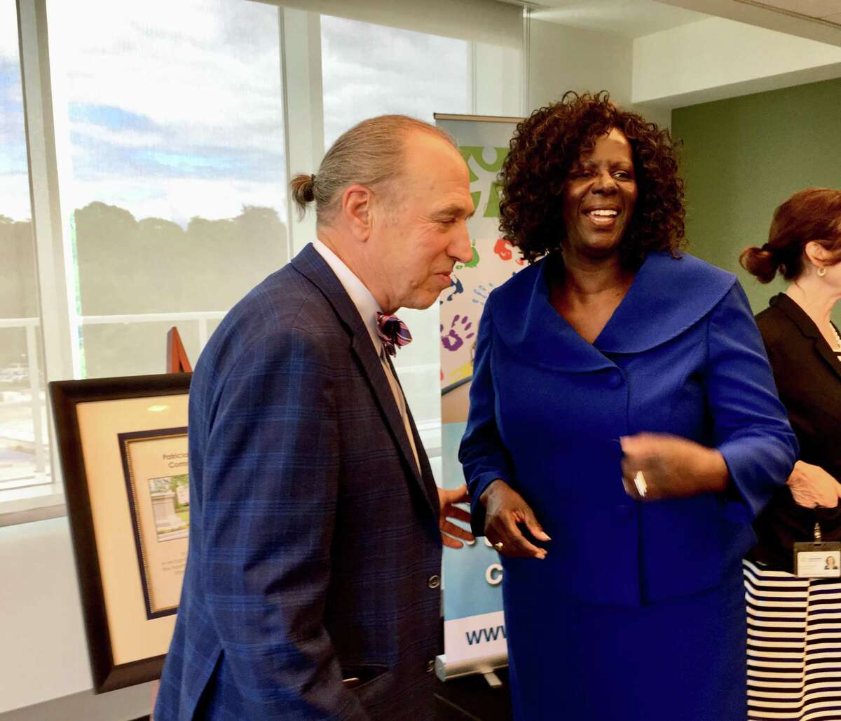 Rep. Patricia Billie Miller, D-Stamford, talks with Mark Masselli, CEO of Community Health Center Inc., after the group dedicated a community room at its new Stamford clinic in Miller's honor.