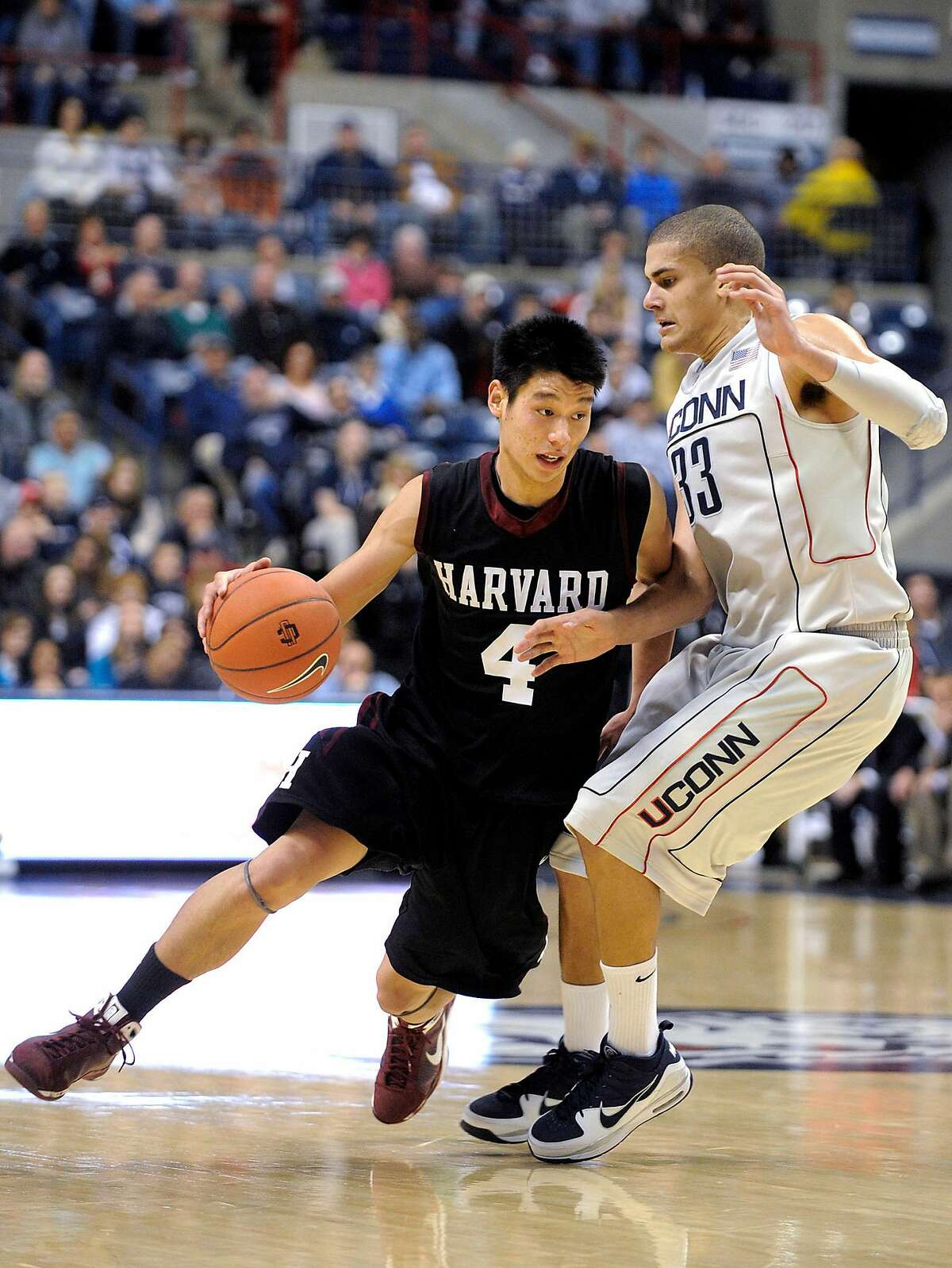 Harvard's Jeremy Lin, left, drives past Connecticut's Gavin Edwards during the second half of Connecticut's 79-73 victory in their NCAA college basketball game in Storrs, Conn., on Sunday, Dec. 6, 2009. Lin scored a game-high 30 points with nine rebounds and Edwards scored 12 points with five rebounds.
