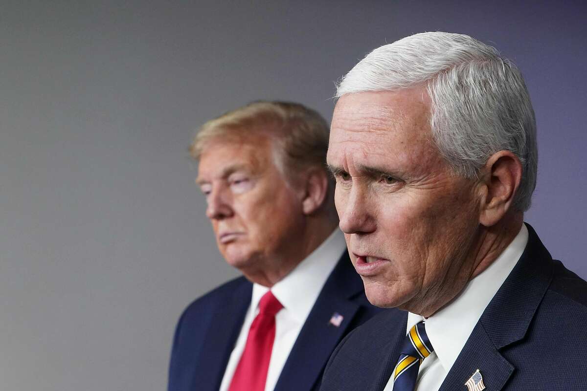 President Trump listens to as Vice President Mike Pence speaks a coronavirus briefing in April. Calls were growing Thursday for Pence to invoke the 25th Amendment to remove Trump from office after Wednesday’s mob attack on the U.S. Capitol.