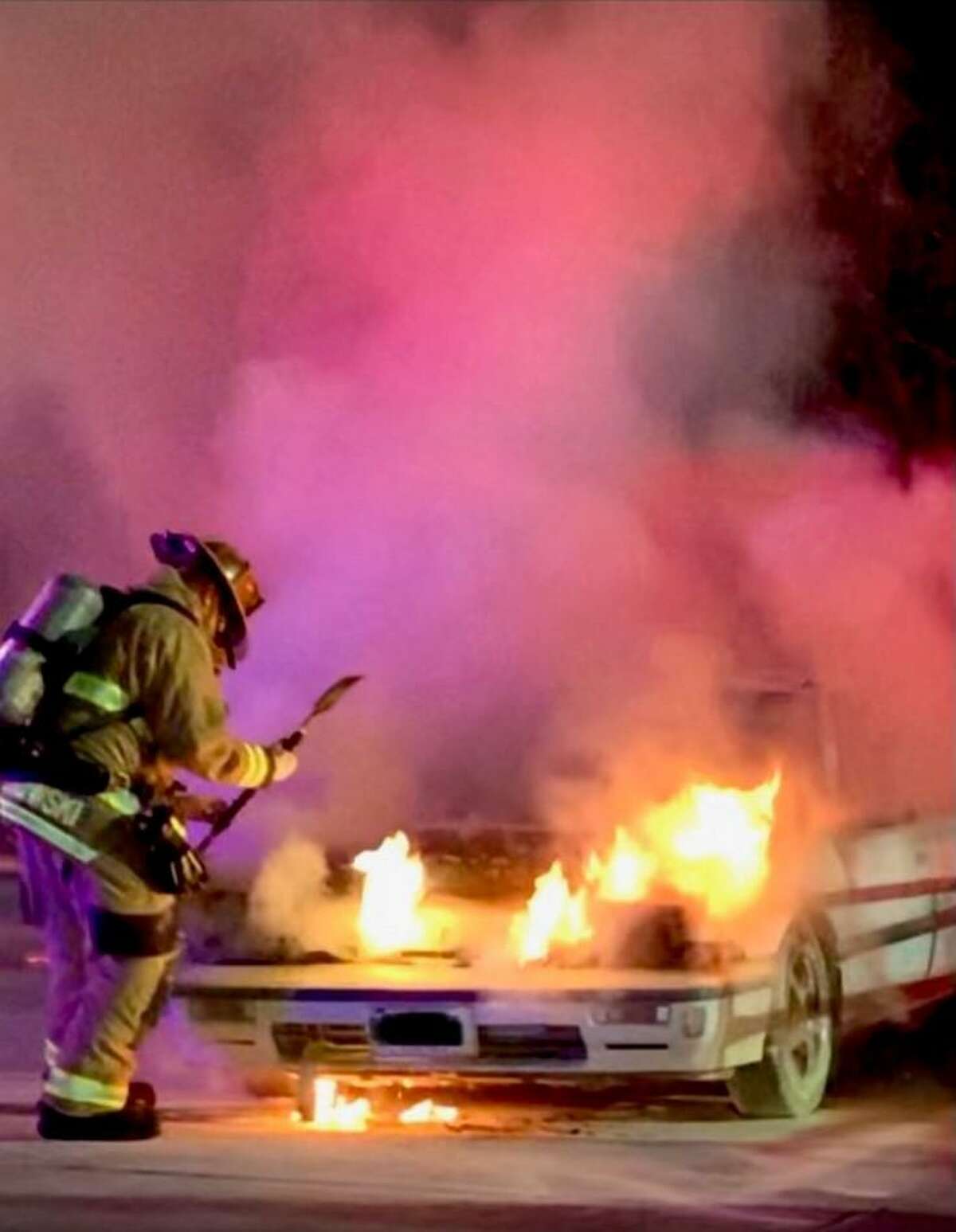 Shelton firefighters battle a car fire in the Walmart parking lot on Thursday, Dec. 7.