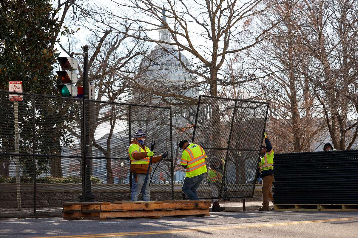 Workers install fences in front of The U.S Capitol building after massive protest as Trump supporters entered the building in Washington D.C., United States on January 07, 2020. (Photo by Tayfun Coskun/Anadolu Agency via Getty Images)