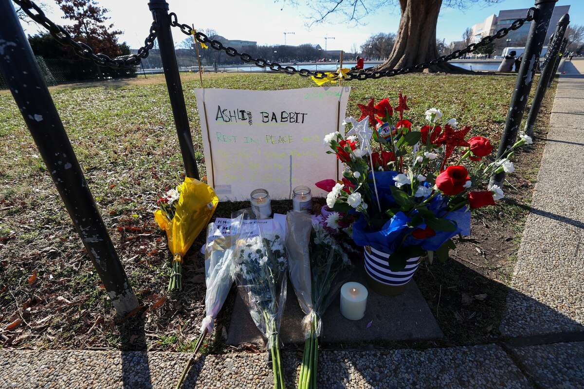 People place flowers and candles for Ashli Babbit, an Air Force veteran who was shot and killed in the U.S Capitol building yesterday was honored by The U.S Capitol building in Washington D.C., United States on January 07, 2020. (Photo by Tayfun Coskun/Anadolu Agency via Getty Images)