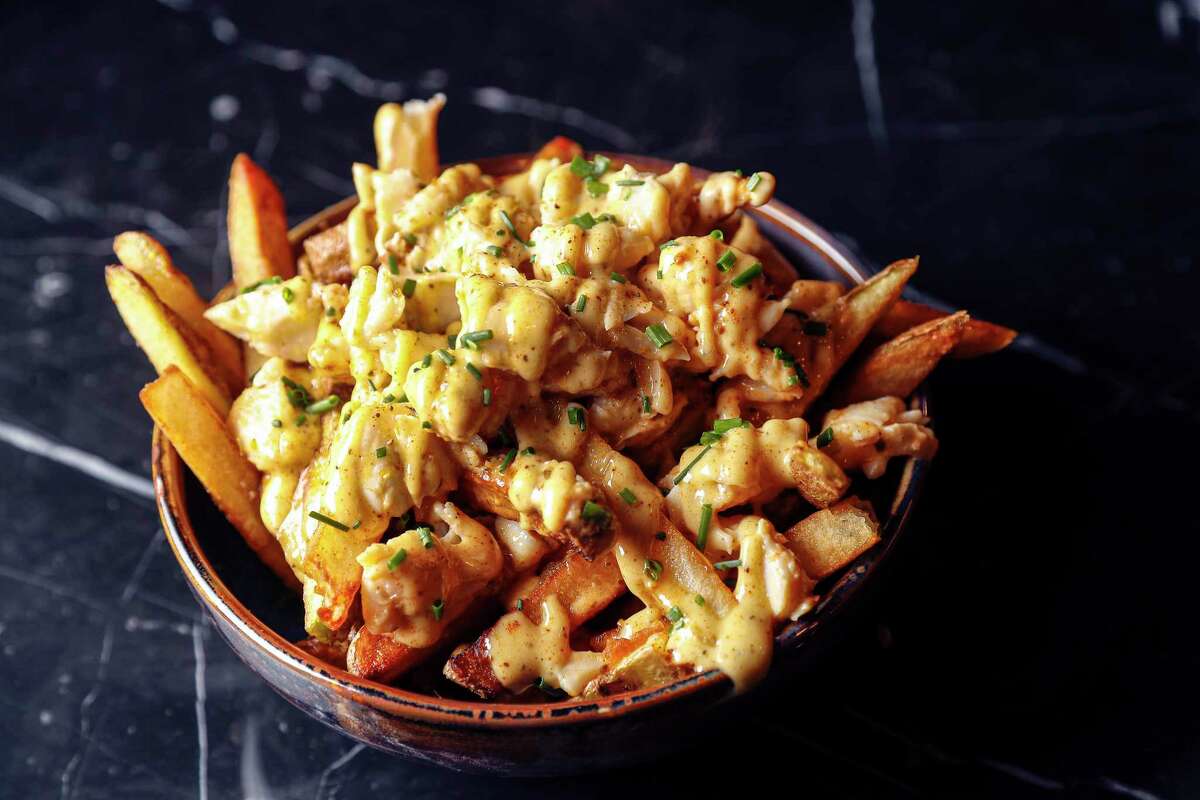 Old Bay crab fries: Fries with Maryland crab, cream sauce and Old Bay crab cream sauce at James Harden's new restaurant Thirteen,Wednesday, Jan. 6, 2021, in Houston .