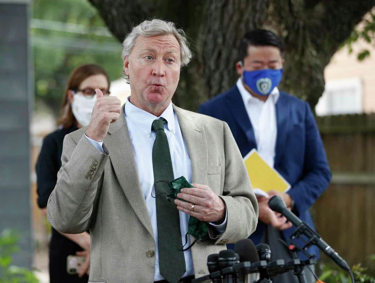 Attorney Mike Doyle representing Rhogena Nicholas speaks to the media with State Rep. Gene Wu and other lawmakers to address the HPD Narcotics Division audit, Thursday, July 2, 2020, in Houston, in front of the home where Rhogena Nicholas and Dennis Tuttle, were killed on Harding Street.