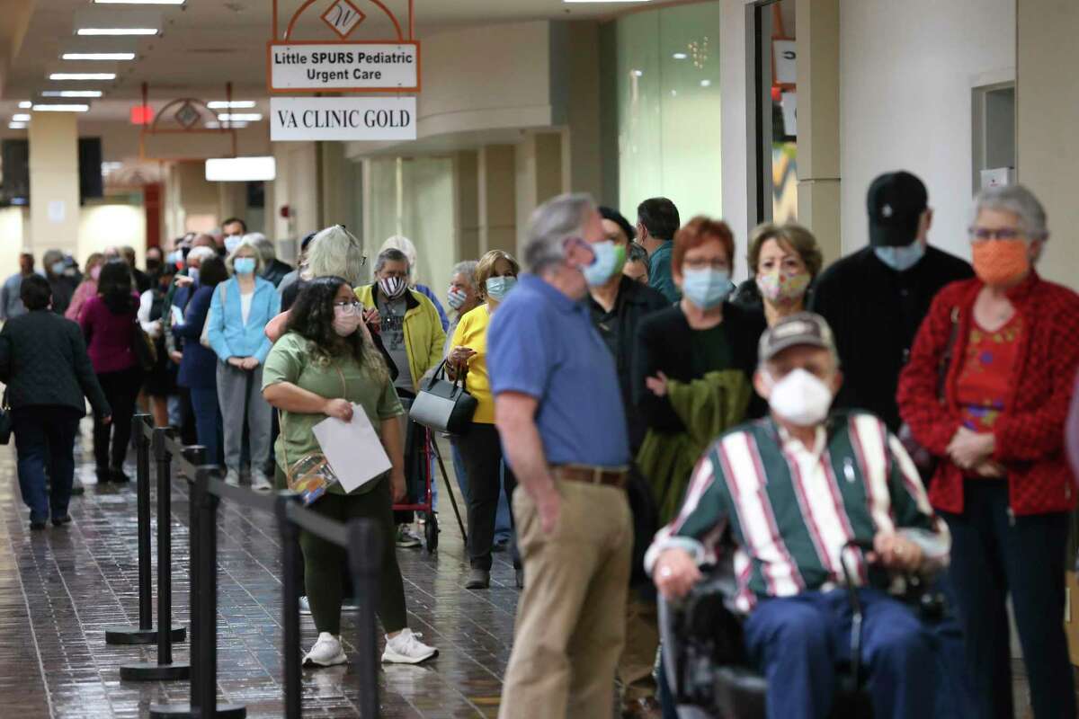 People line up for the Moderna COVID-19 vaccine administered by University Health at Wonderland of Americas Mall, Monday, Jan. 4, 2021. It is the first day of vaccinating people in the 1B group, those 65 years and over and 18 and above with certain medical conditions. The 17,280 vaccination slots were taken up in five hours after University Health opened the website for registration on Dec. 31.