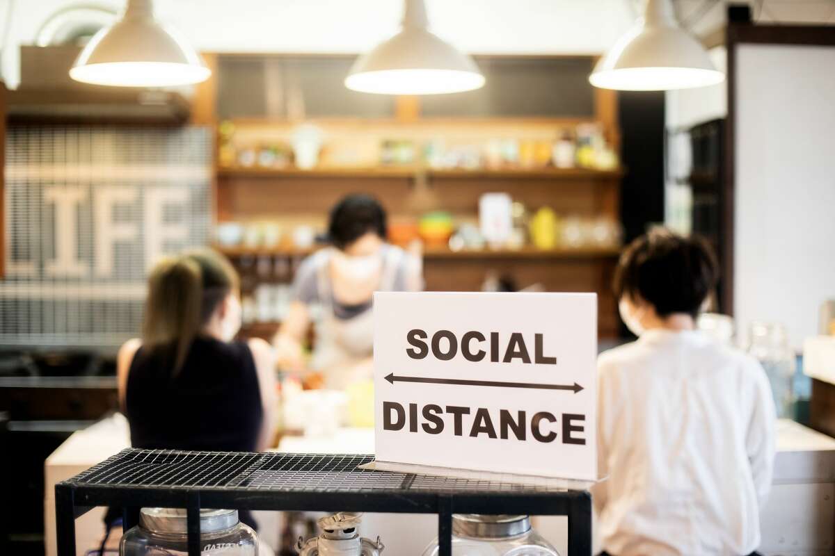 A family has social distancing concerns while eating at a restaurant.