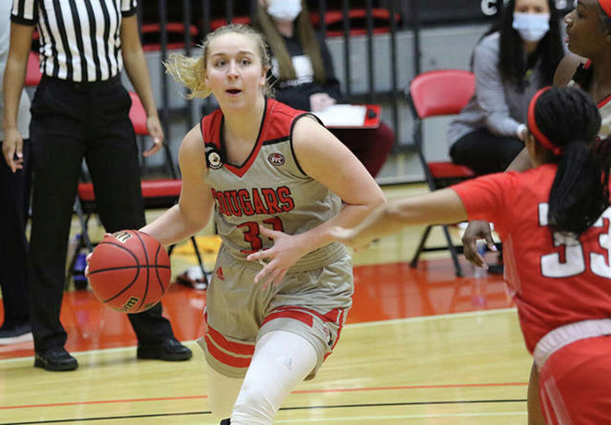 SIUE’s Caite Knutson (left), a freshman from Collinsville, takes the ball to the basket against Austin Peay’s Brandi Ferby on Thursday at First Community Arena in Edwardsville.