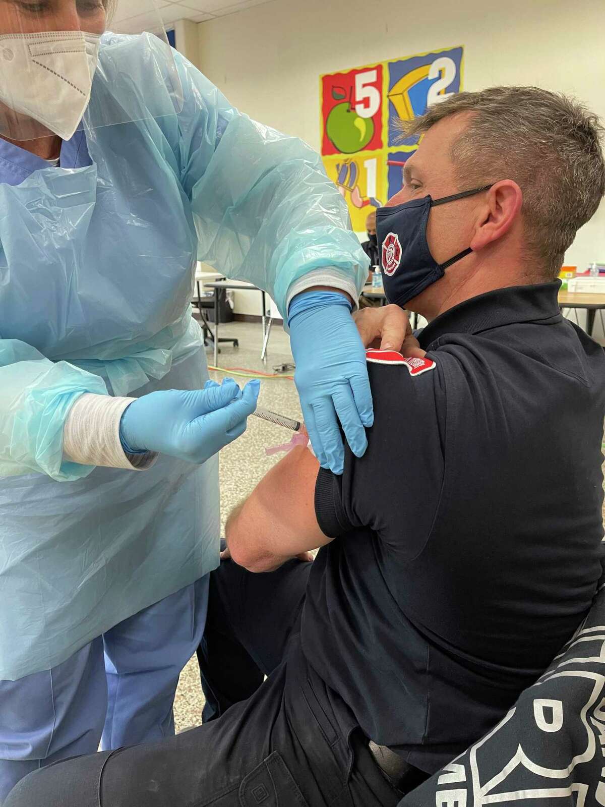 Nurse Maureen Singer administers the Moderna COVID vaccine to Danbury fire Lt. Mark Miguel on Wednesday, Dec 30, 2020. The Danbury Health Department administered 300 COVID vaccines over the course of a week to health care workers and first responders.