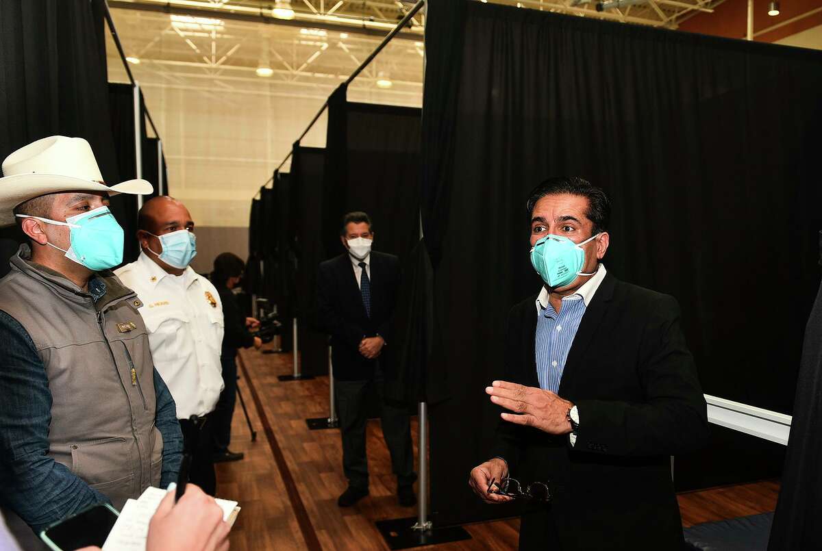 Texas Division of Emergency Management 's Gerardo Castillo and Dr. Rashid Chotani answer questions for the media, Friday, Jan. 8, 2021, during a media walk-through of an infusion center for mild COVID-19 cases at the Haynes Recreation Center.
