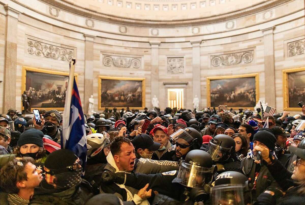 WASHINGTON D.C., USA - JANUARY 6: Police intervenes in US President Donald Trumps supporters who breached security and entered the Capitol building in Washington D.C., United States on January 06, 2021. Pro-Trump rioters stormed the US Capitol as lawmakers were set to sign off Wednesday on President-elect Joe Biden's electoral victory in what was supposed to be a routine process headed to Inauguration Day. (Photo by Mostafa Bassim/Anadolu Agency via Getty Images)