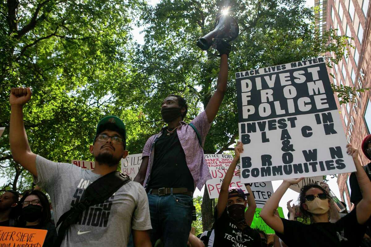 Isaiah Adams, 23, holds up a mega phone as he leads protesters in a chant outside the Paul Elizondo Tower Building in downtown San Antonio, Texas, on June 9, 2020. Protesters met in front of the Bexar County Courthouse, a day after Bexar County District Attorney Joe Gonzales said due to lack of new evidence and information he did not plan to review the cases of Marquise Jones, Charles Roundtree and Antronie Scott, all of whom were killed by San Antonio police officers.