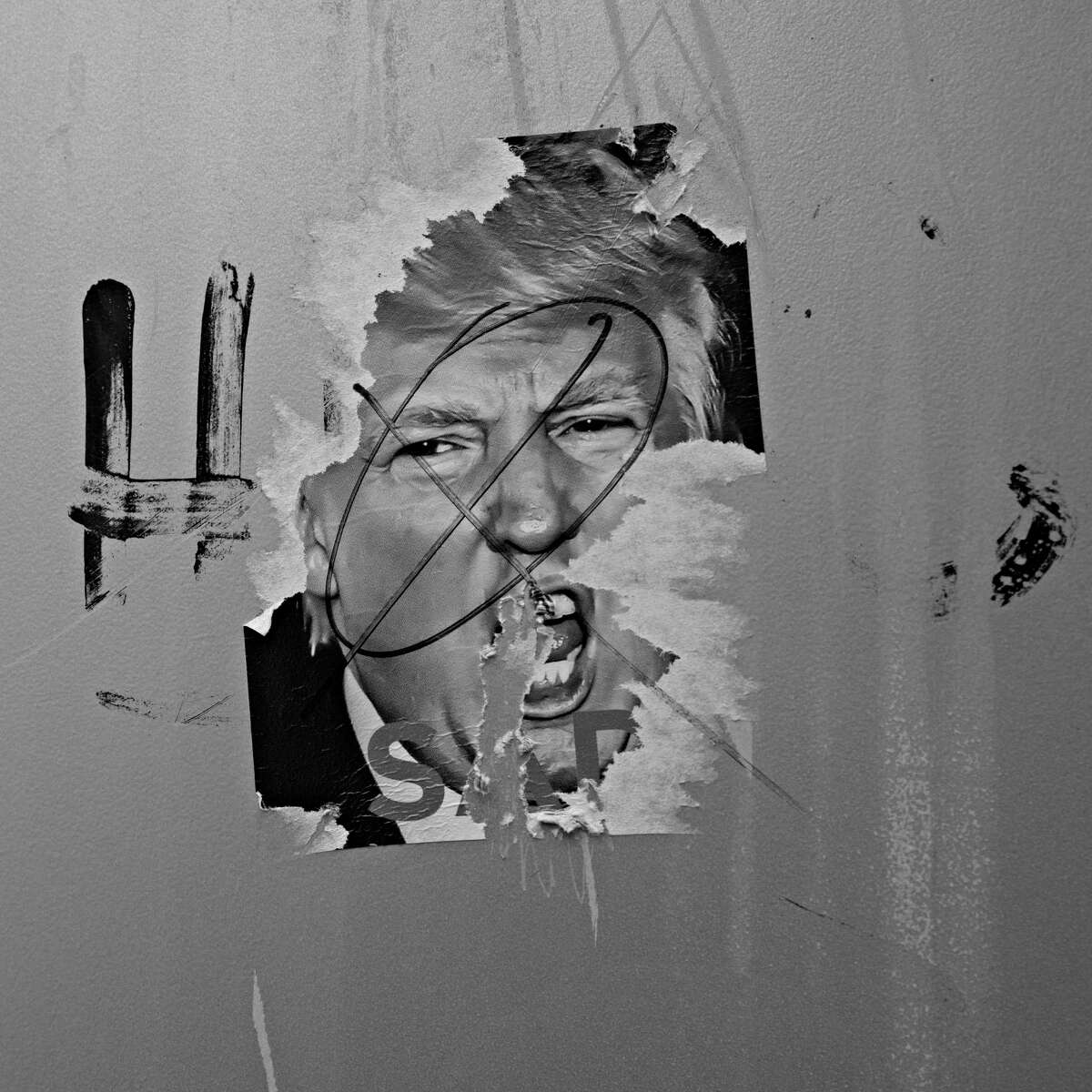 WASHINGTON, DC | January 8, 2021 A defaced sticker of President Donald Trump is seen on 15th ST NW near the White House. Two days after a mob of Trump supporters stormed the U.S. Capitol, Washington, DC is a ghost town with fences and barricades now surrounding key buildings, and a handful of Army and Air National Guard as well as police officers from Maryland, Virginia and DC guarding the city.