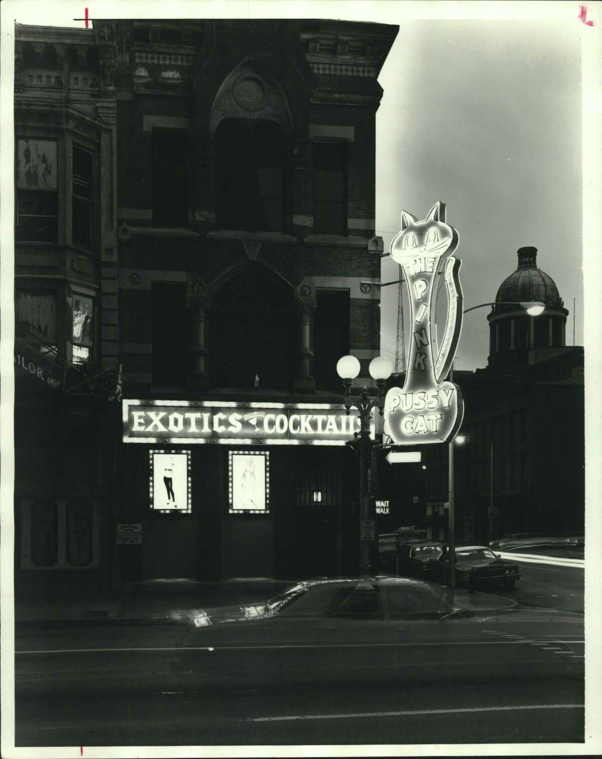 This iconic bright pink neon sign marks the Pink Pussy Cat lounge in Houston at the corner of Main and Congress avenues in 1979. The building was demolished in 1983.
