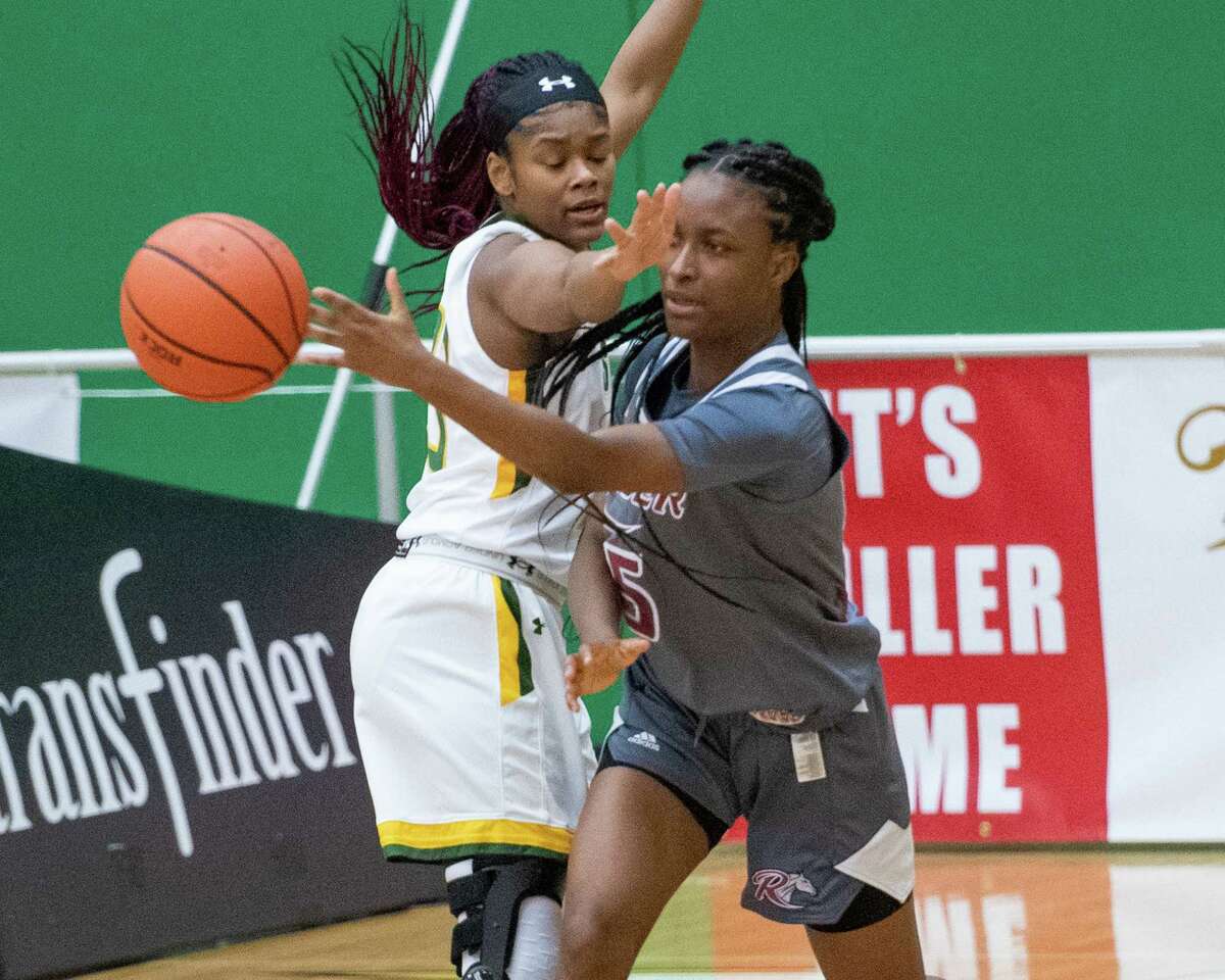 Rider University sophomore Maya Hyacienth passes the ball in front of Siena College graduate student Isis Young during a Metro Atlantic Athletic Conference game at the Alumni Recreation Center on the Siena campus in Loudonville, NY, on Saturday, Jan. 9, 2020 (Jim Franco/special to the Times Union.)