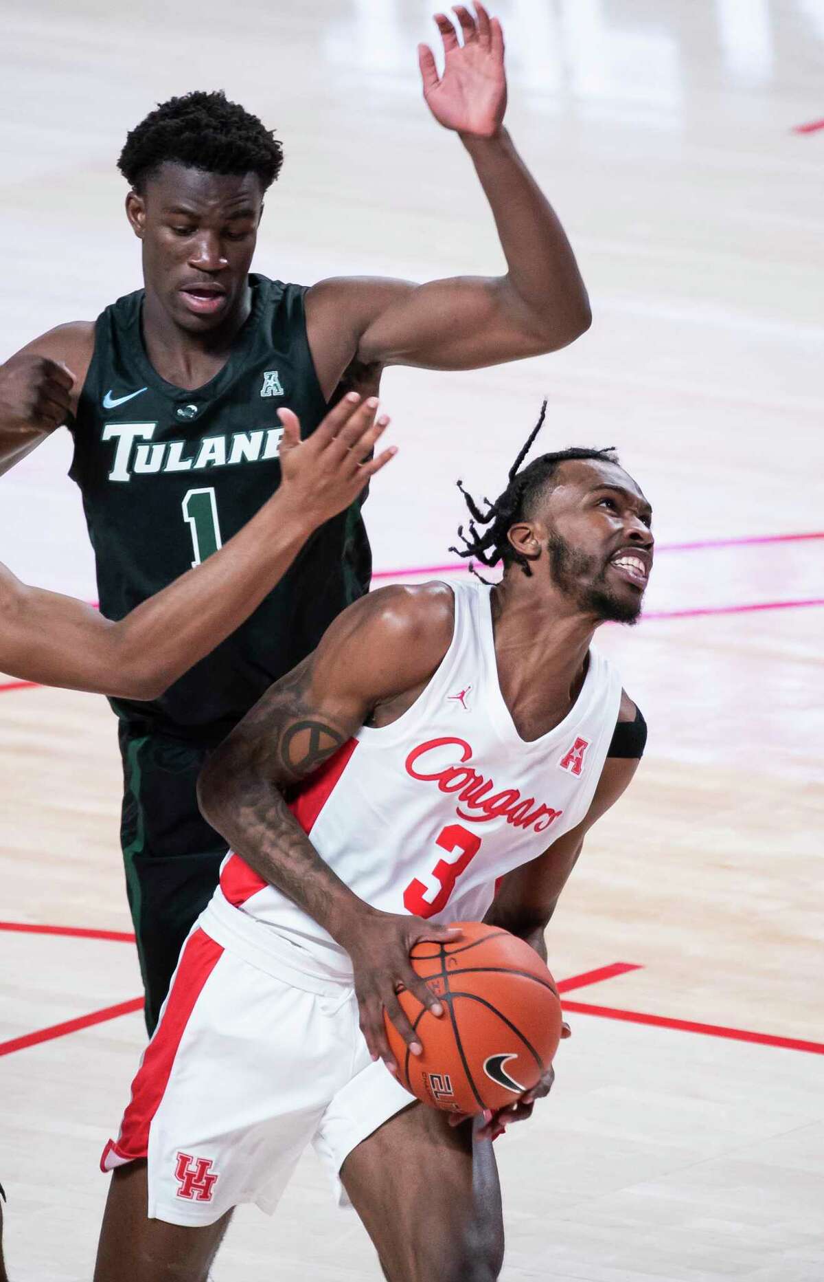 Houston Cougars guard DeJon Jarreau (3) drives past Tulane Green Wave guard Sion James (1) during the first half of a game between the University of Houston Cougars and the Tulane University Green Wave on Saturday, Jan. 9, 2021, at the Fertitta Center in Houston.