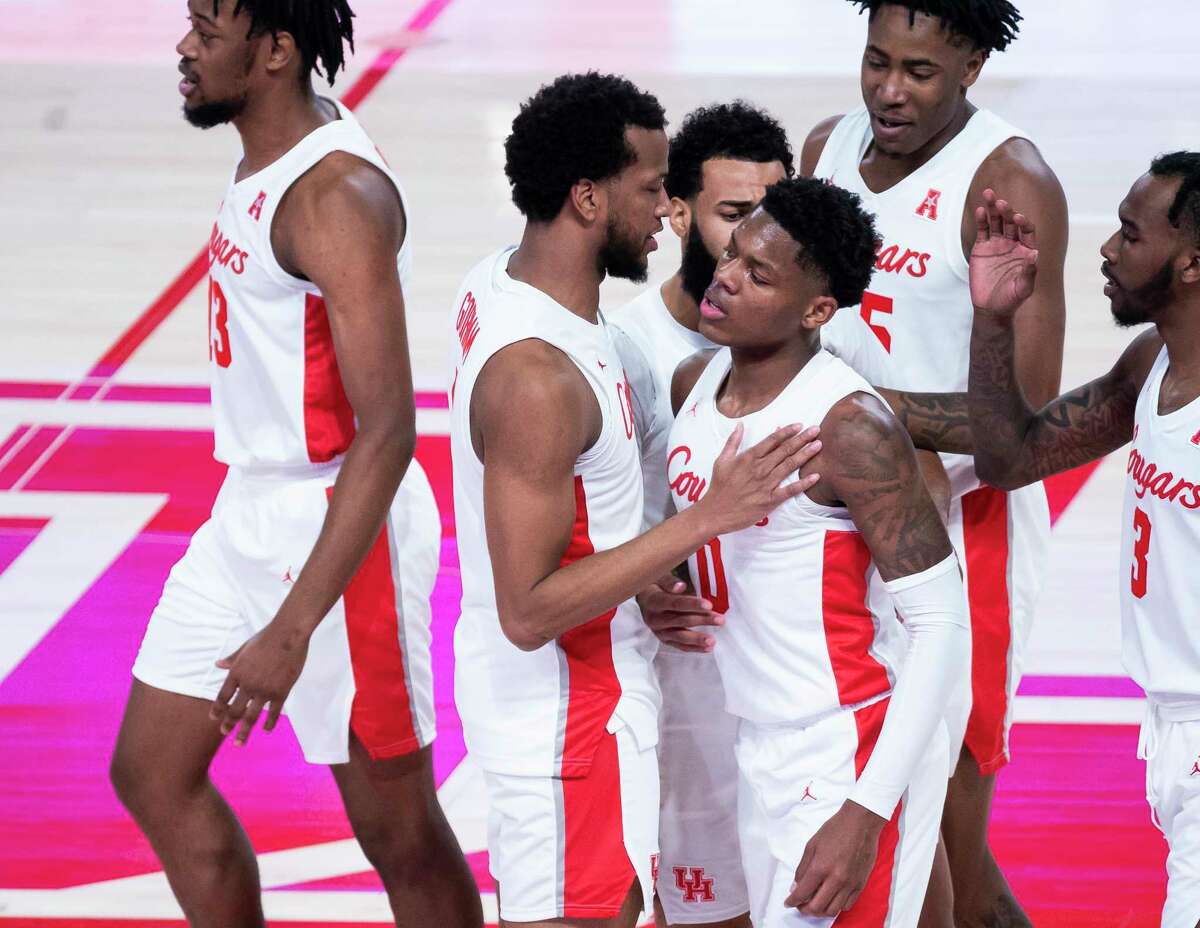 Houston Cougars guard Marcus Sasser (0) is met by his teammates during a timeout after hitting a shot during the first half of a game between the University of Houston Cougars and the Tulane University Green Wave on Saturday, Jan. 9, 2021, at the Fertitta Center in Houston. Sasser finished with 28 points and was 8-15 from three point range.