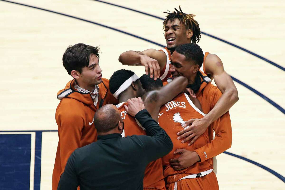 Texas players celebrate after defeating West Virginia on a last-second shot by Andrew Jones.