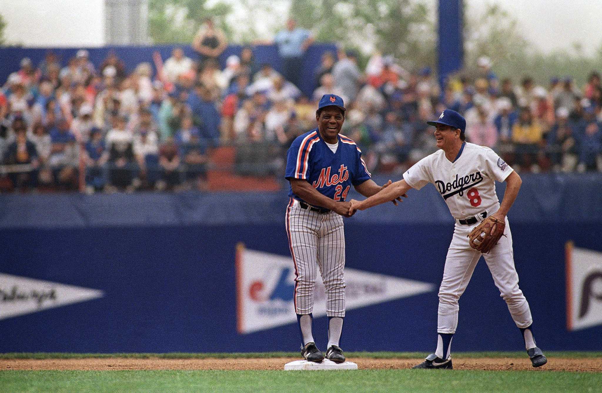 Dodgers third base coach Dino Ebel, back in blue, finds himself in