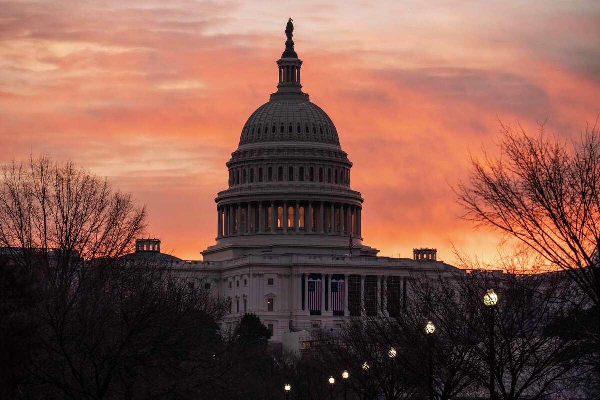 Dawn breaks at the Capitol in Washington, Monday, Jan. 11, 2021.