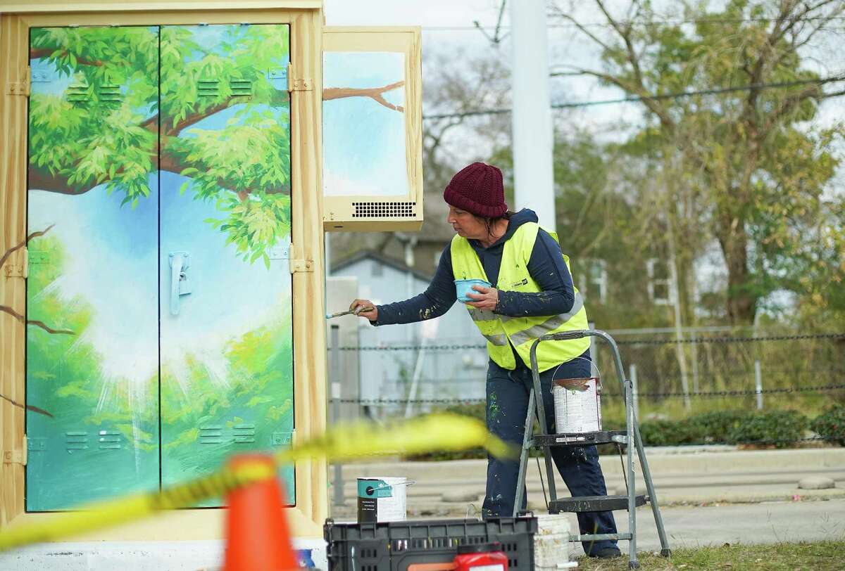 Houston-base artist Anat Ronen paints a mural to bring attention to human trafficking on a Metro cabinet near Moody Park in Houston on Friday, January 8, 2021.