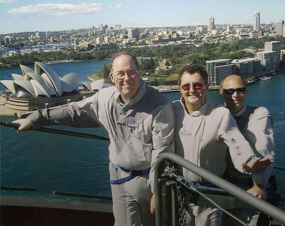 Houston Chronicle sports writers (from left) David Barron, Fran Blinebury and Danny Robbins stand at the top of the Sydney Harbour Bridge while in Australia to cover the 2000 Summer Olympics. Barron is retiring from the Chronicle this month after 31 years with the newspaper.