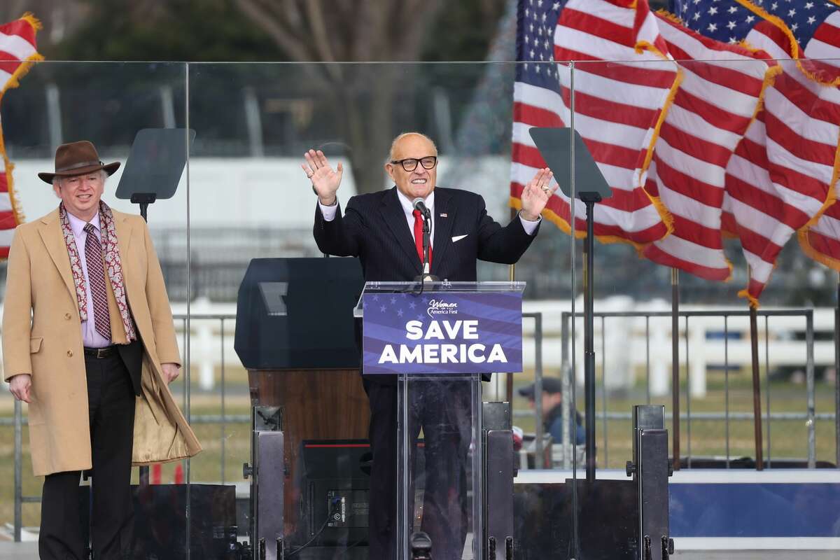 Chapman University professor John Eastman stands next to Rudy Giuliani, personal lawyer to President Donald Trump, during a rally near the White House in Washington, D.C., on Wednesday, Jan. 6, 2021.
