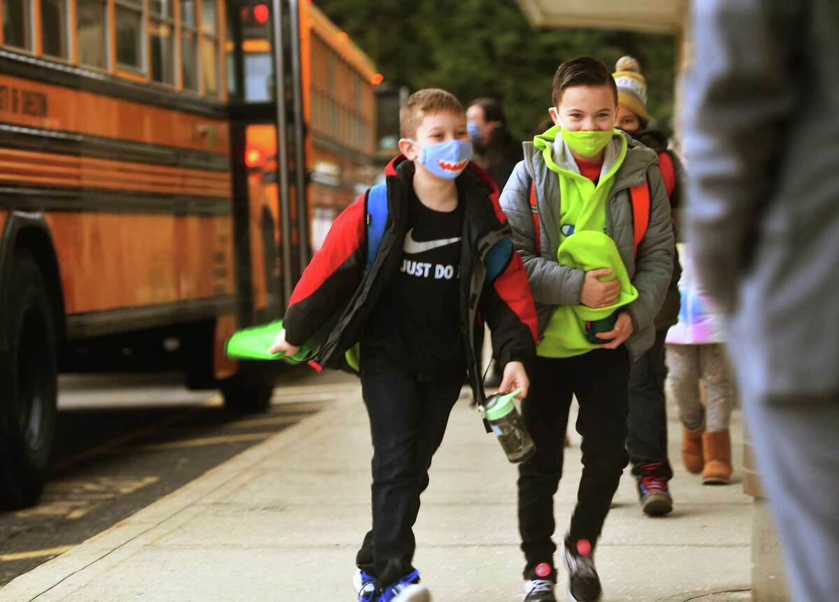 Students return to school after two months of remote home instruction at Long Hill Elementary School on Monday.
