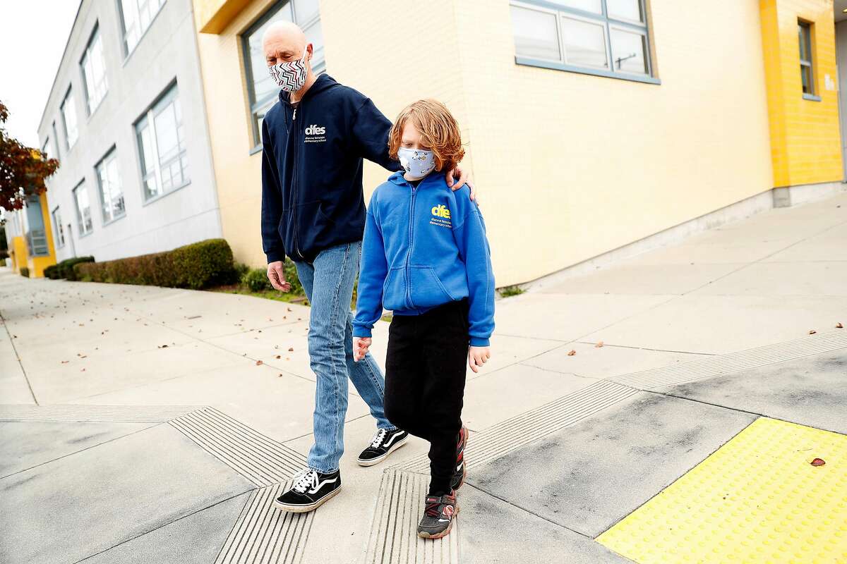 Bryan McDonald and his second grade son, Travis, outside Dianne Feinstein Elementary School in San Francisco, Calif., on Sunday, January 10, 2021. McDonald objects to the school board's demand that the school change its name.