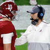 Mac Jones #10 of the Alabama Crimson Tide speaks with Steve Sarkisian during the first quarter of the College Football Playoff National Championship game against the Ohio State Buckeyes at Hard Rock Stadium on January 11, 2021 in Miami Gardens, Florida. (Photo by Michael Reaves/Getty Images)