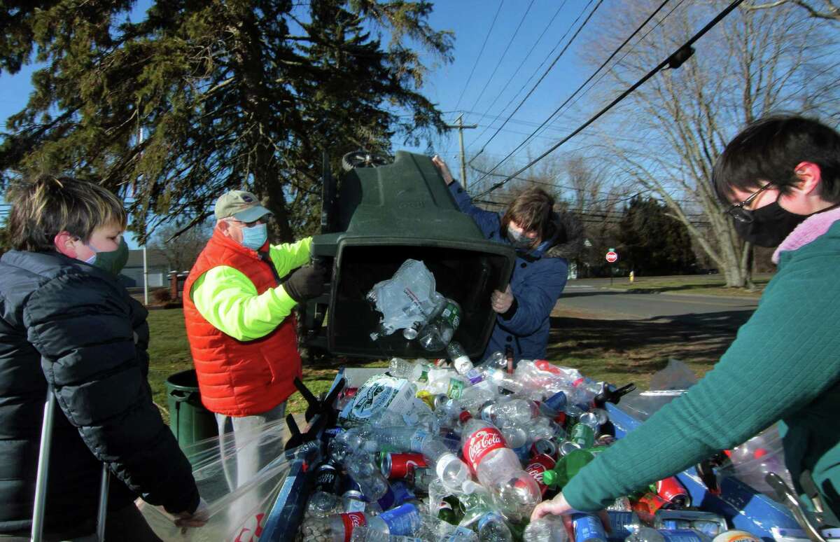Boy Scout Troop 25 holds its monthly redeemable bottle and can drive at First United Methodist Church on Saturday. From left to right is scout Tim Andrade, 12, Dave Mills, Maggie Andrade and Meg Andrade.