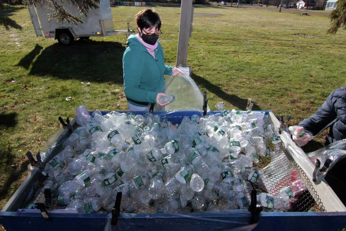 Meg Andrade sorts plastic bottles during Boy Scout Troop 25's monthly redeemable bottle and can drive at First United Methodist Church in Shelton, Conn., on Saturday Jan. 9, 2021. The event, which helps raise money for scouting activities, is held each first Saturday of each month from 10 a.m. to 1 p.m.