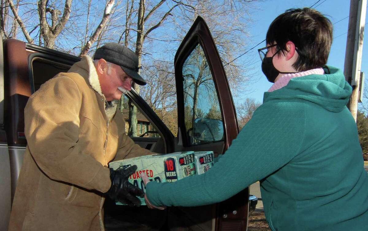 Boy Scout Troop 25 holds its monthly redeemable bottle and can drive at First United Methodist Church in Shelton, Conn., on Saturday Jan. 9, 2021. The event, which helps raise money for scouting activities, is held each first Saturday of each month from 10 a.m. to 1 p.m.